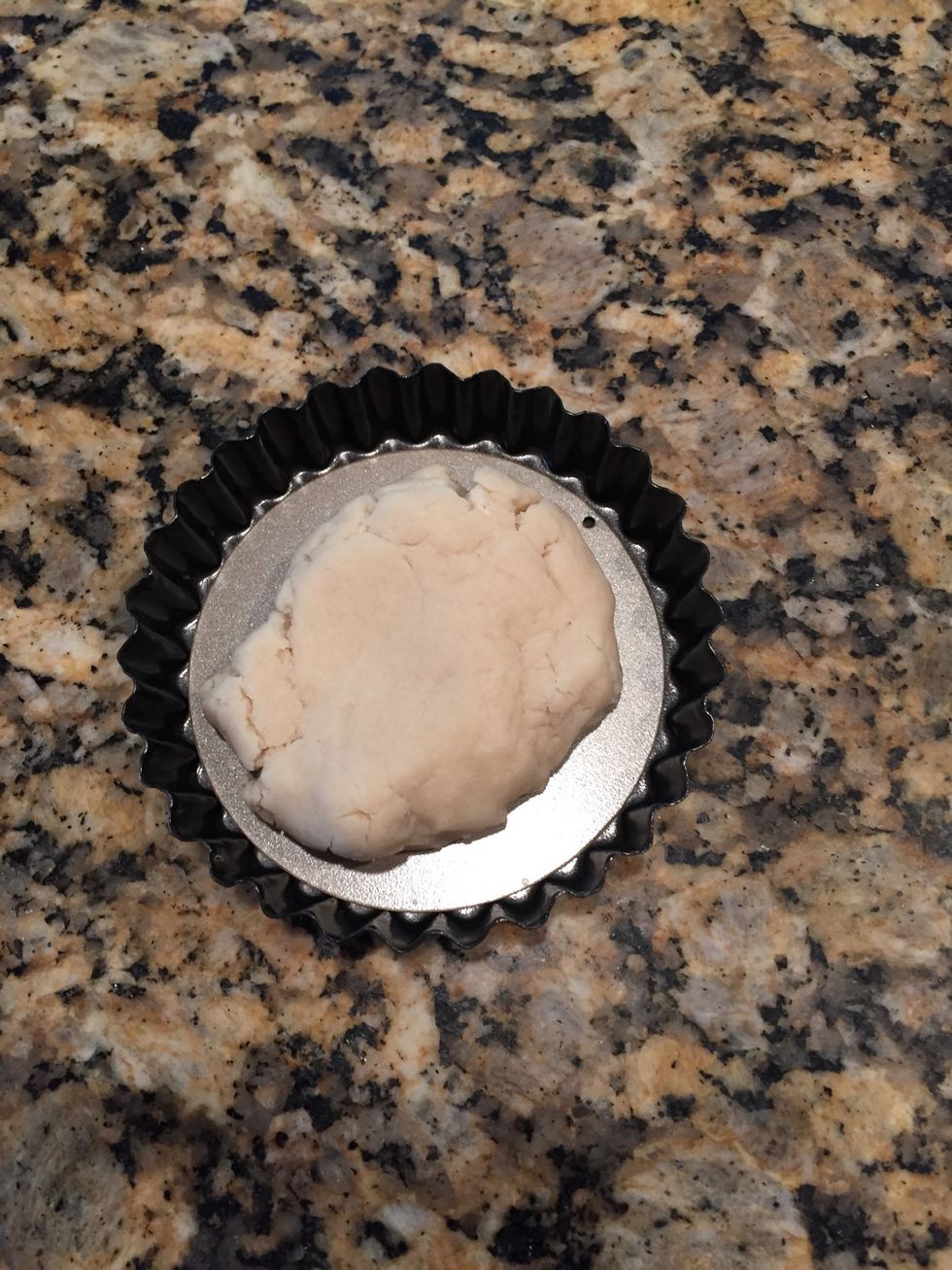 Place a small fist full of dough in tartlet plate