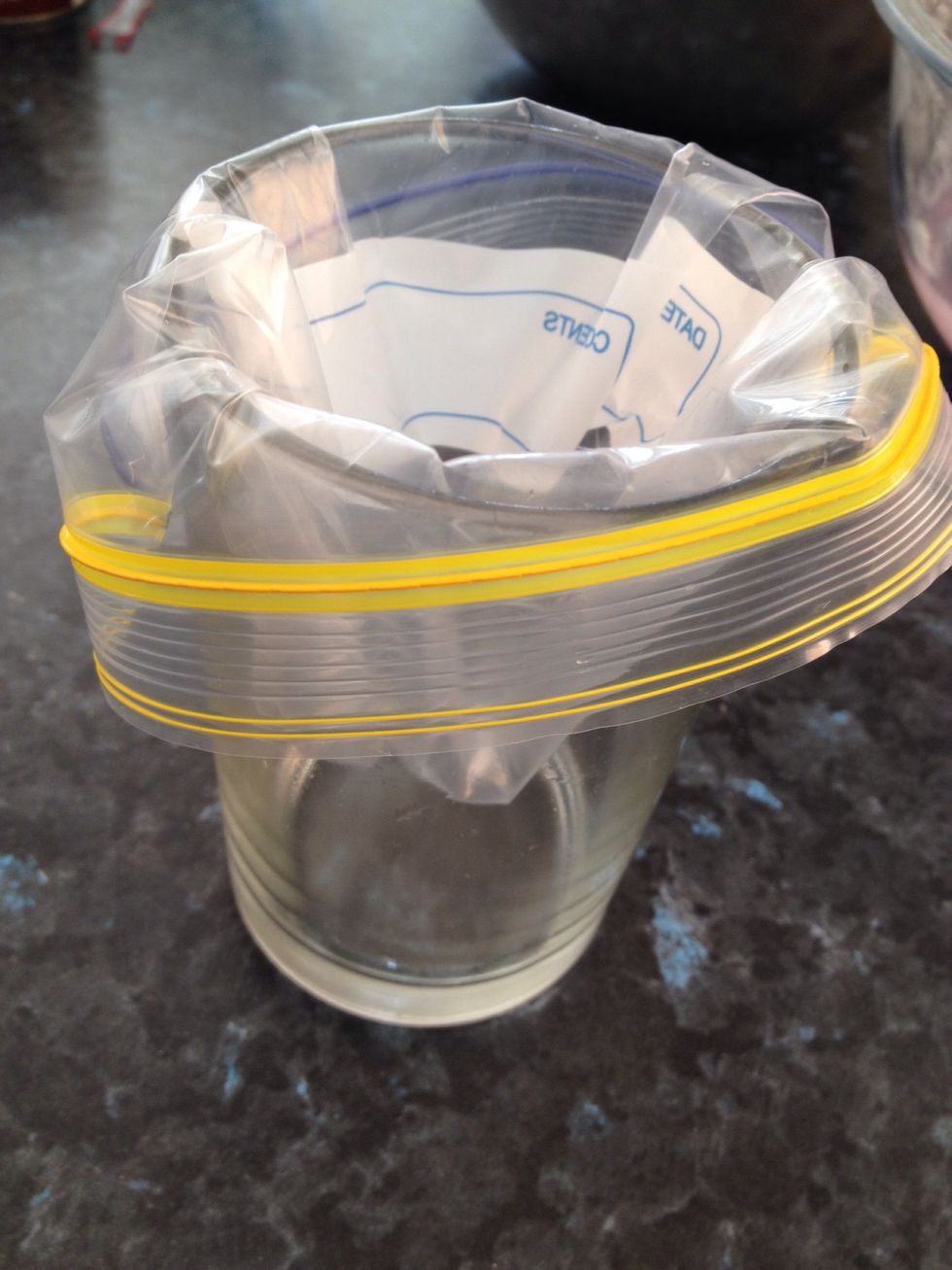 Place a snap-lock bag inside of a cup. This makes it a lot easier to spoon the mixture into it.