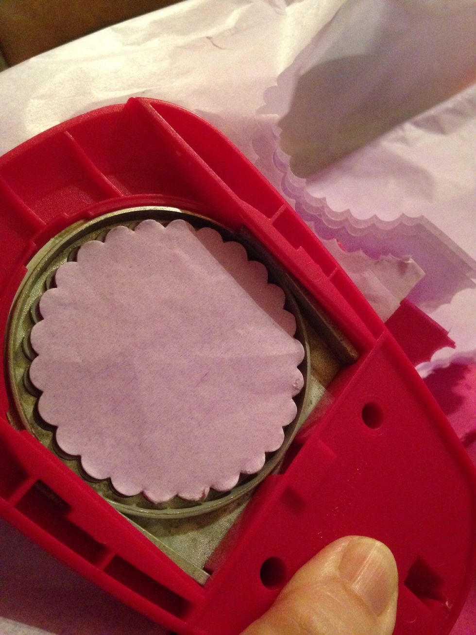 Place a stack of tissue paper together and punch out with scallop punch.  Each flower takes eight circles, and that is the thickness of tissue I made (8 sheets) to punch