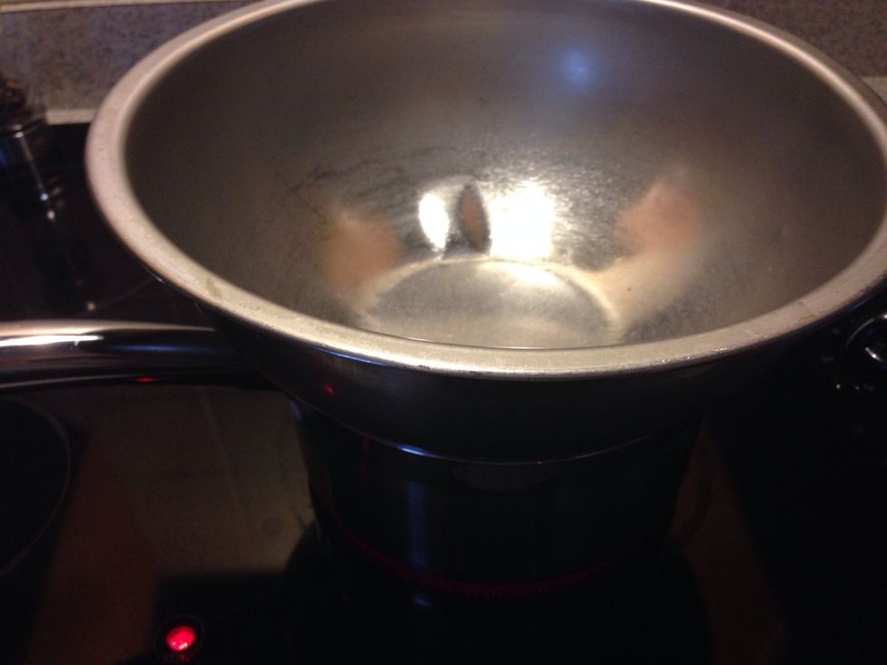 Place a stainless steel mixing bowl on top of your boiling pot of water.