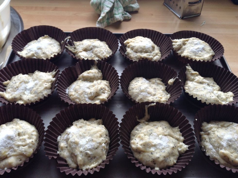 Place a tablespoon of the mix into each case, and sprinkle with the sugar and lemon mix that was placed to one side