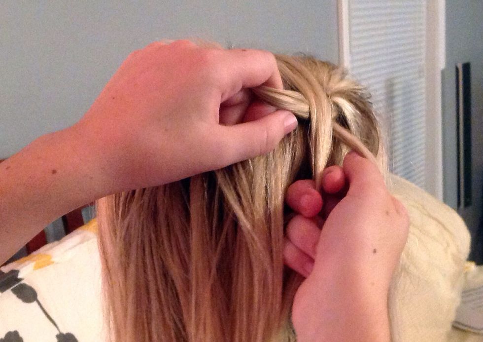 Place a third strand in between the first two pieces of hair.