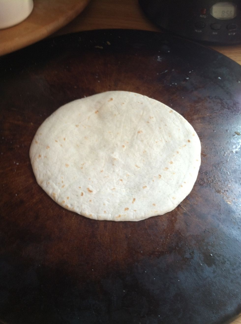 Place a tortilla on an oven stone. (I like to use minis)