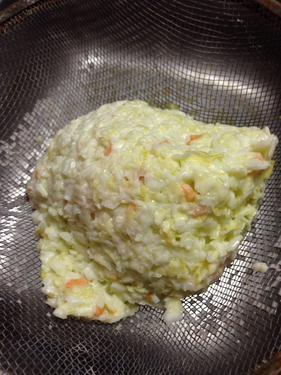 Place about a cup or so of the premade slaw into a mesh strainer. Press to remove a lot of the liquid. You don't want a soggy sammich.