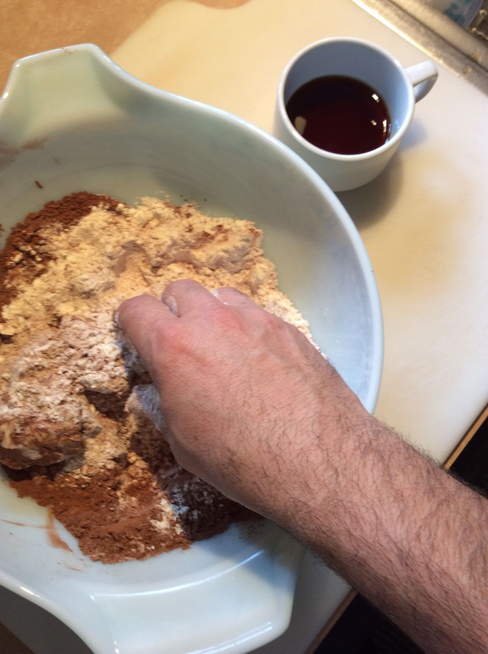 Place all ingredients in a large mixing bowl except the cold coffee or espresso. Use your hands or a pastry blender, blend the ingredients together to create loose pea sized crumbs.