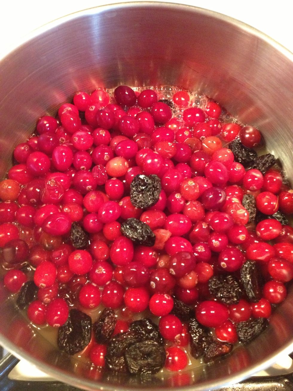 Place all ingredients in a medium sauce pan and stir well. Cook on medium until the cranberries start to pop.
