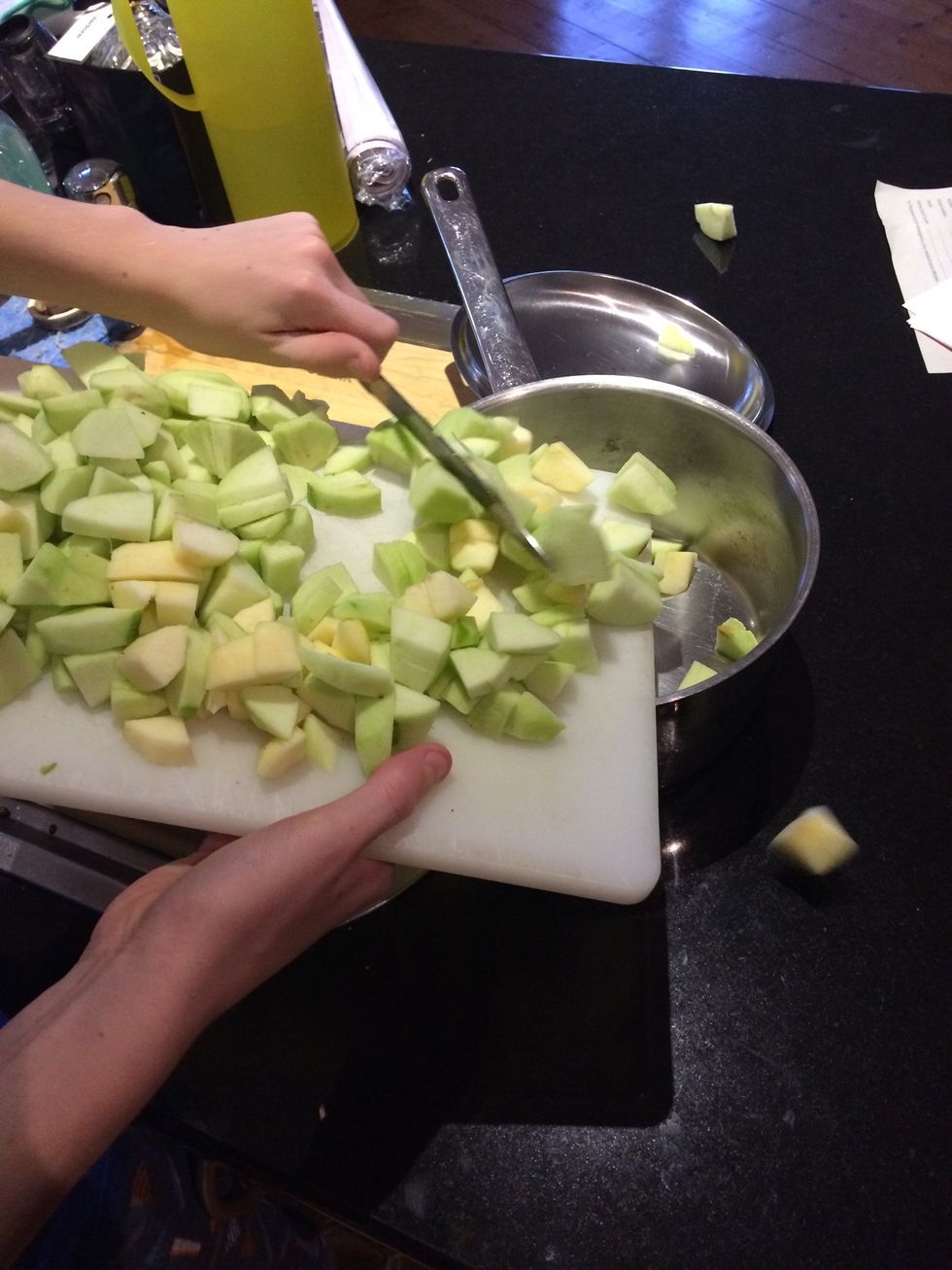 Place all of the apples into a saucepan