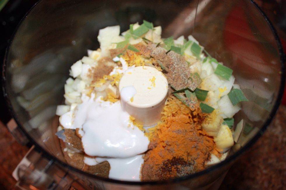 Place all of the aromatics in a food processor, along with two tablespoons of coconut milk