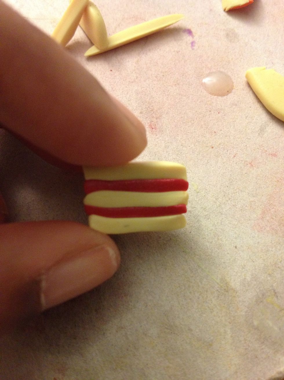 Place all of the slices in order so the icing separates the cake.