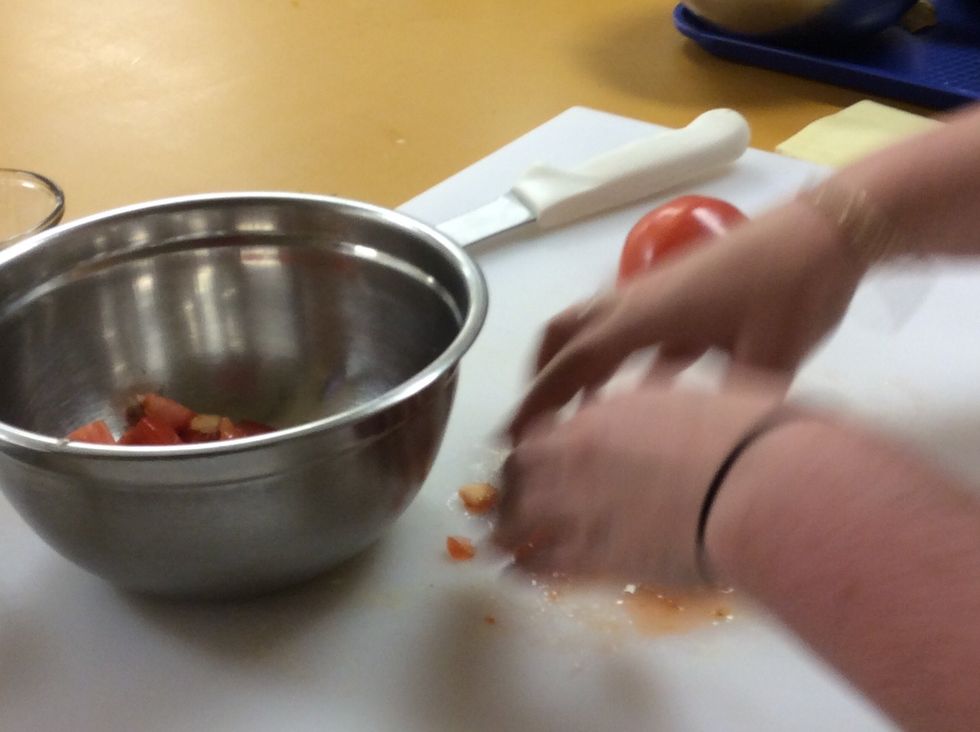 Place all of the tomato in a medium sized bowl.