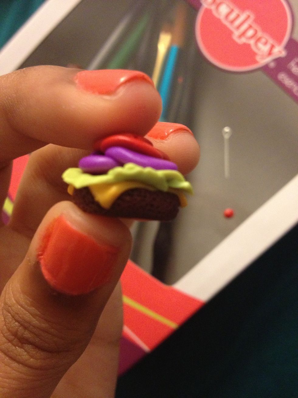 Place all of the toppings on the burger. Remember the inside won't show just the edges, so it doesn't matter if the middle is messy; make sure the visible parts are how you want them to look.
