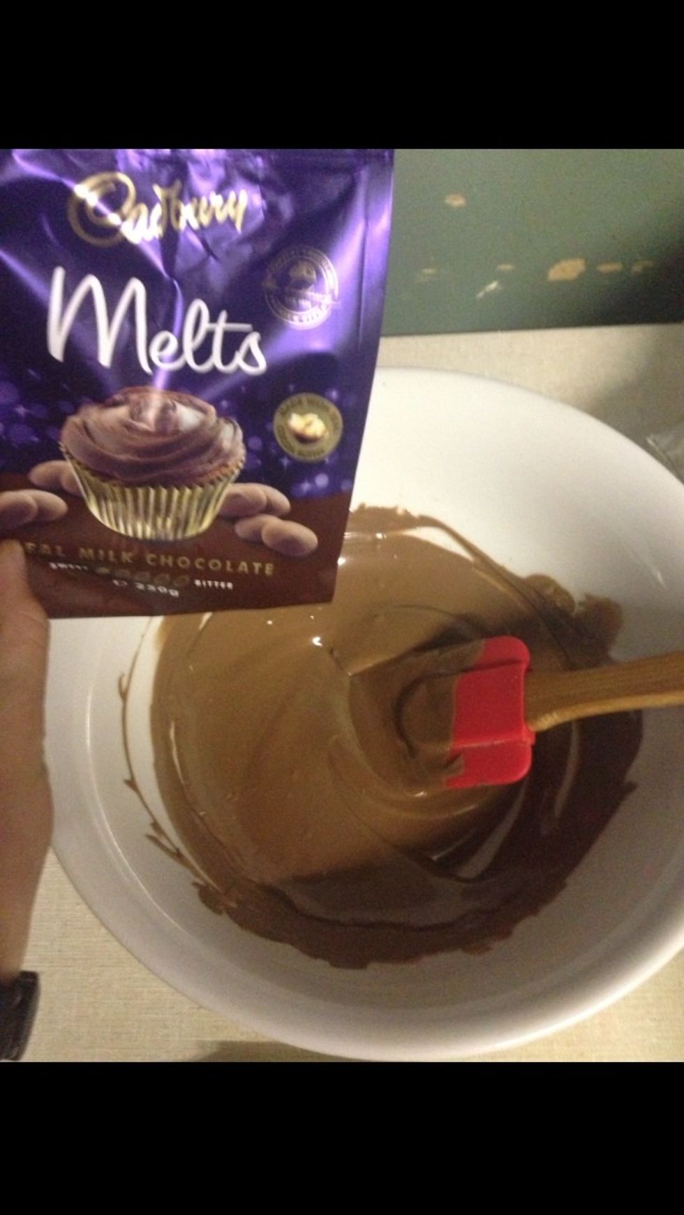 Place all the Cadbury melting drops in a bowl placed over boiling water on the stove! Stir chocolate until smooth and silky. Dip the malted biscuit halves until they are completely covered.