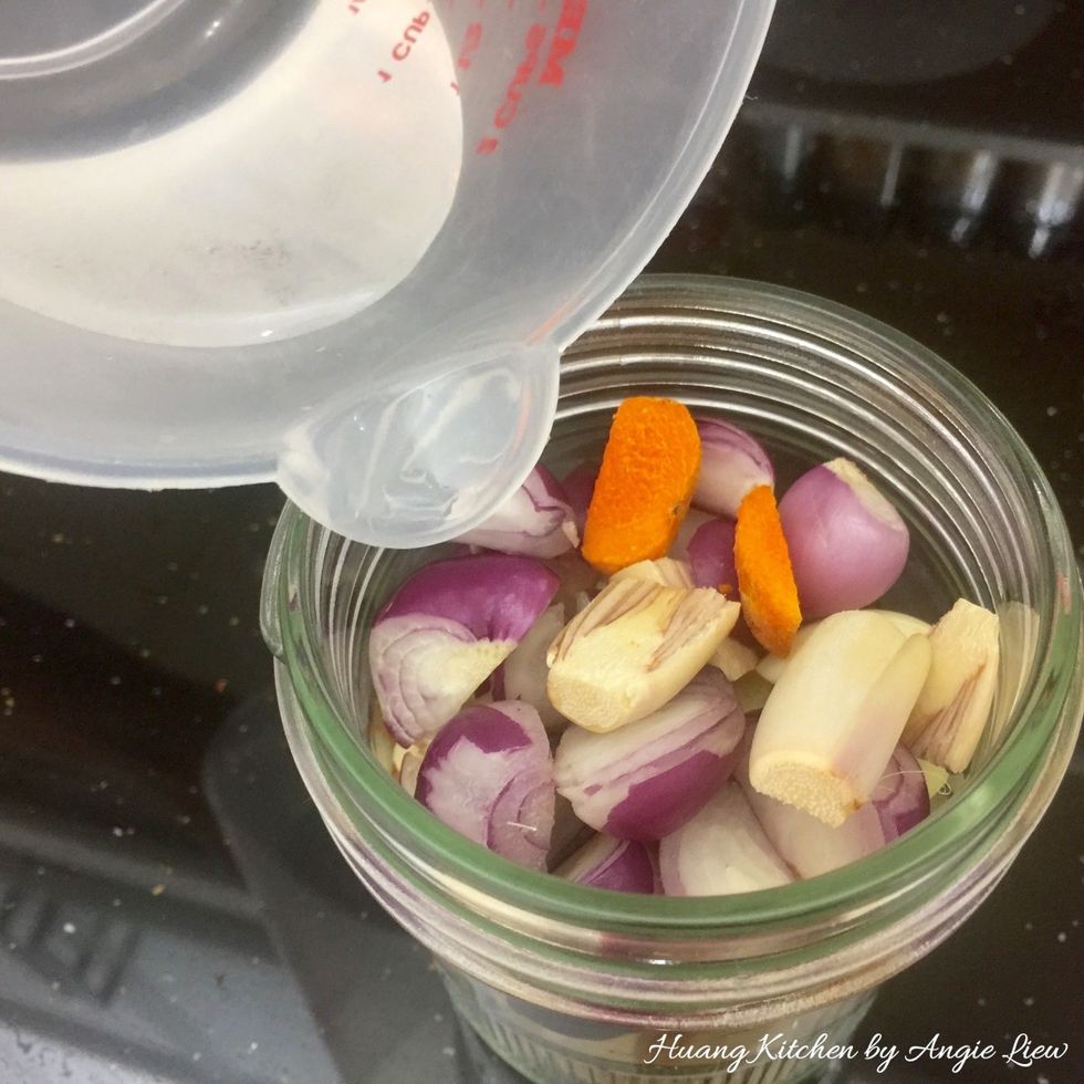 Place all the cut spices and turmeric piece into a blender with a little water added. (Ingredients to be ground {B})