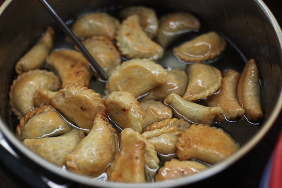 Place all your cooked walnut pouches in the syrup for a few minutes and trust me they will NOT go soggy. Stir them around once or twice.