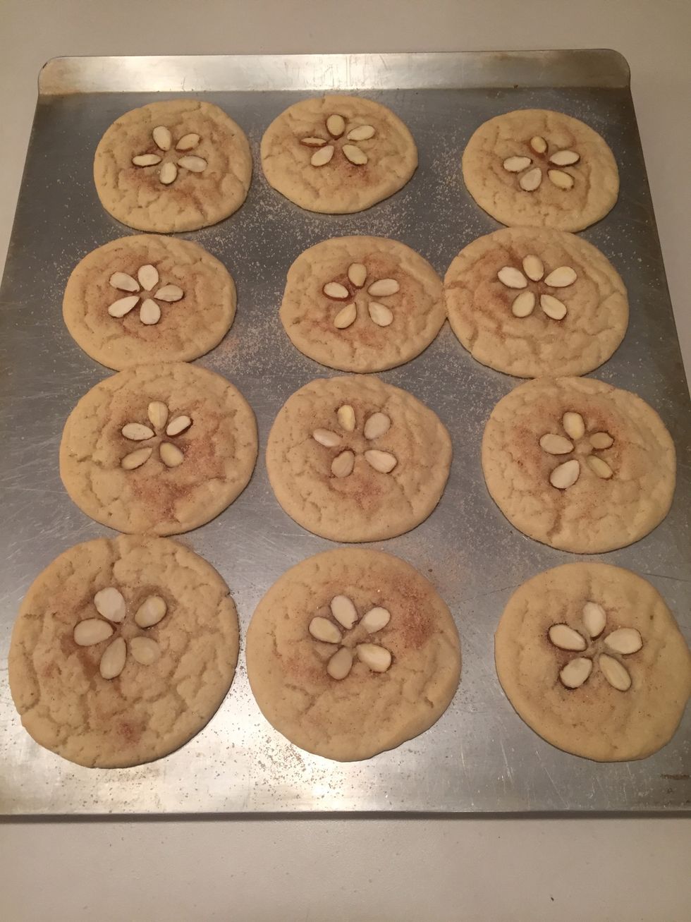 Place almonds in the center of the cookie, pressing in a bit for the almond to "stick" to the cookie.