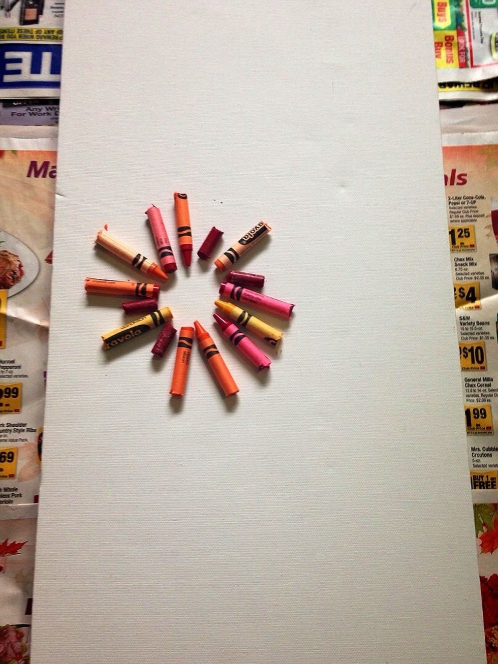 Place and arrange crayons on your canvas to your liking, then glue them down. Work quickly, as the glue does harden fast!