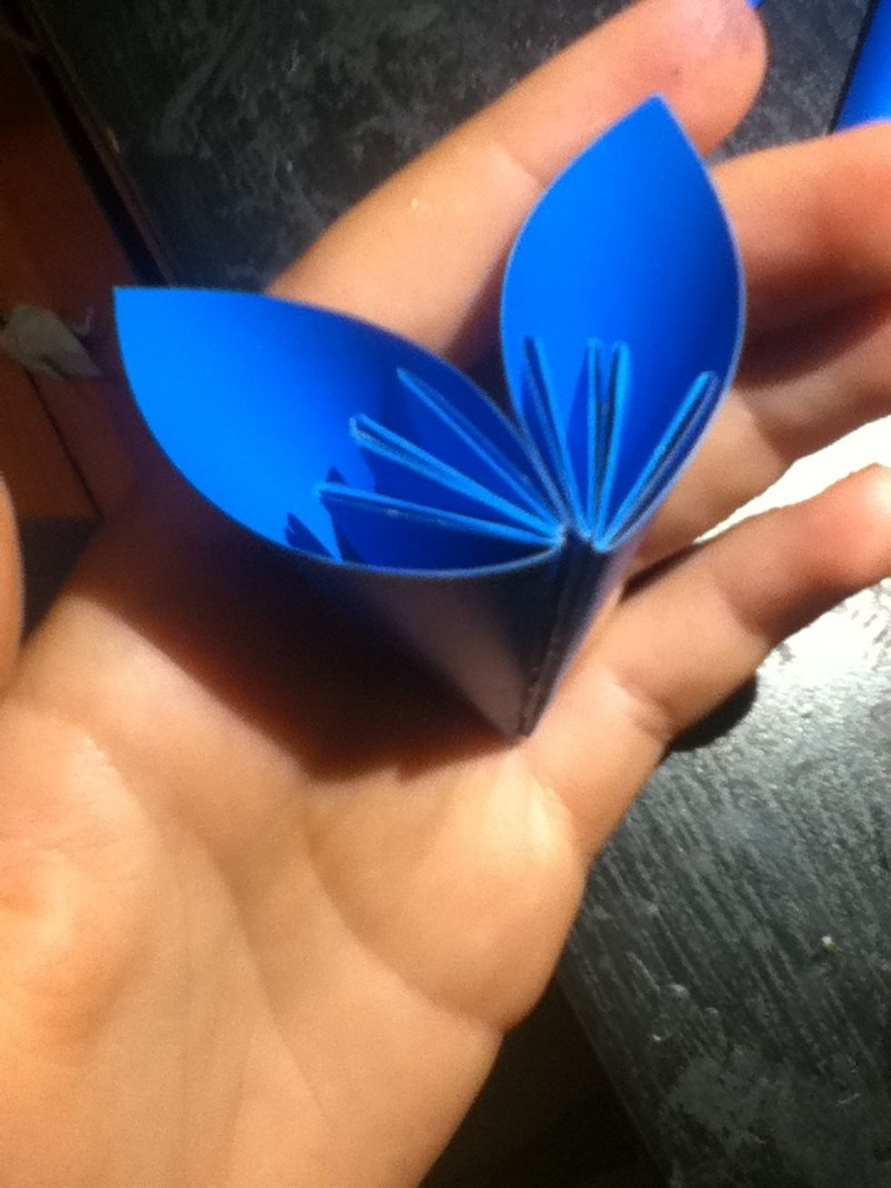 Place another cone's edge on the gluey edge, and hold for a moment to adhere. Make another pair, and set aside.