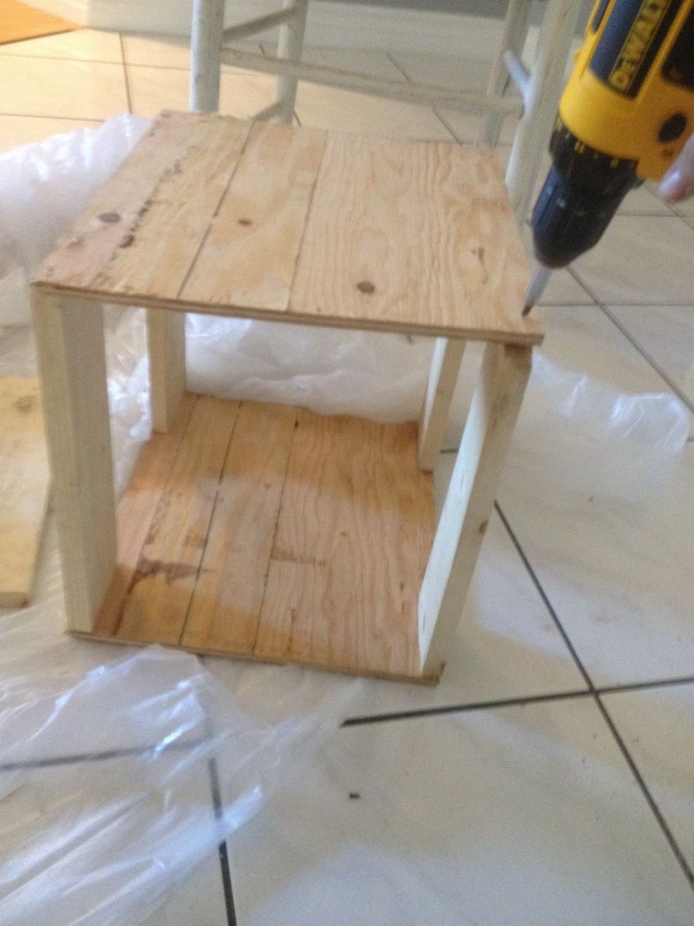 Place another piece of plywood on top, and screw into the other ends of the legs.