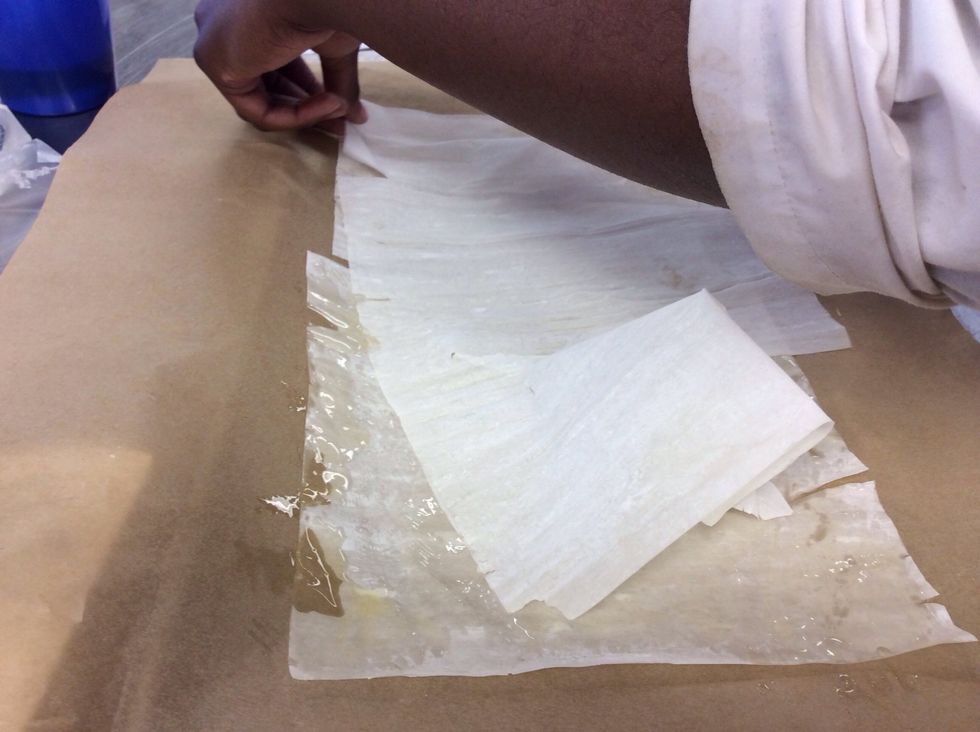 Place another sheet on top of the buttered sheet. Repeat 5 times