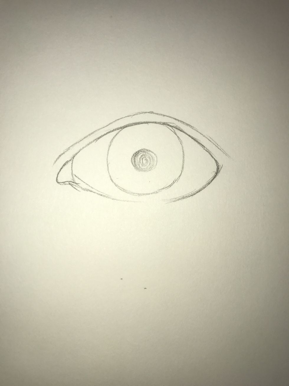 Place another small circle inside the eyeball. This will be the pupil, which is black. Also make a curved line between the inner corner of the eye and the rest.
