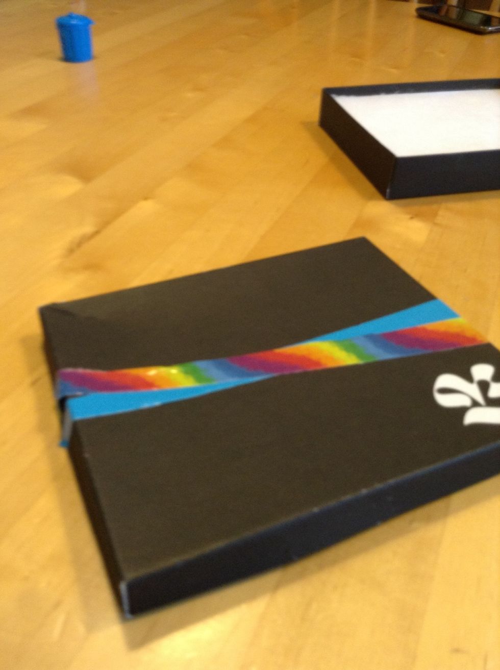 Place another strip in a different colour on a slight diagonal making sure there is no box showing in between the two strips