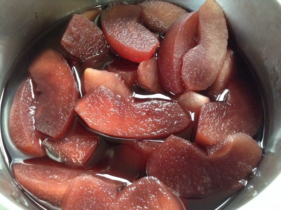 Place apple slices in a saucepan with 2 cups of red wine, \u00bd cup of sugar, and juice of \u00bd lemon. Cover with gauze and simmer for 20 minutes. Cool while you finish off the rest of the wine (optional).