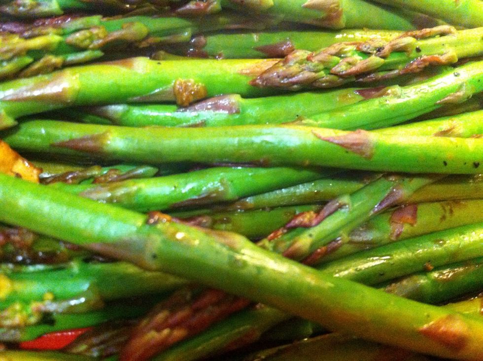 Place asparagus and garlic  in side dish; dress with more lemon juice, olive oil, and salt to taste - these will become more flavorful the longer you let them sit and absorb flavor