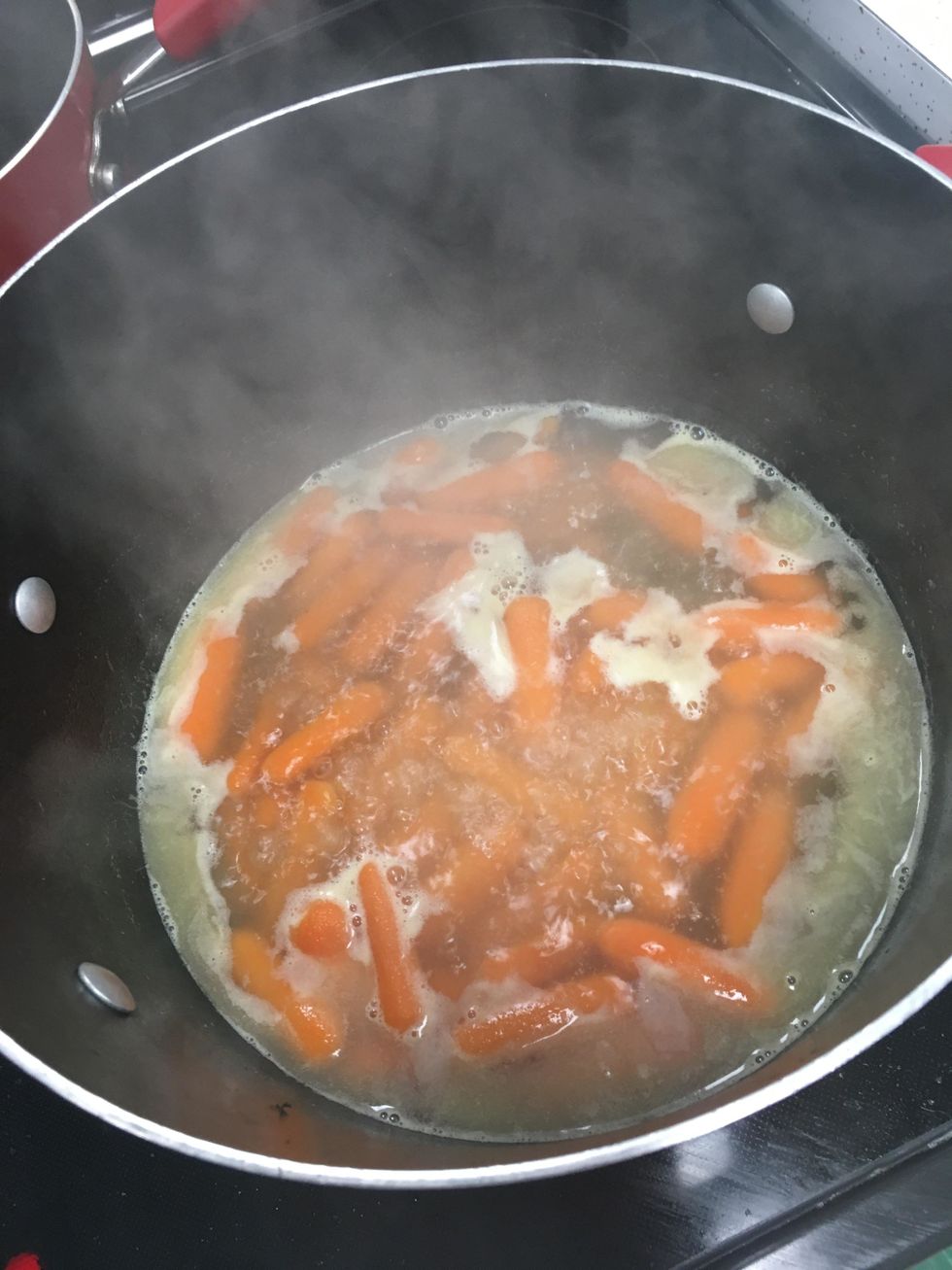Place baby carrots in 1/2-inch of water with butter, sugar, and salt.