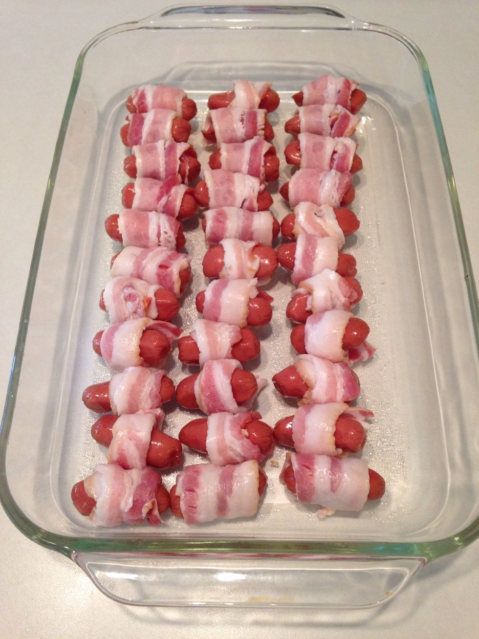 Place bacon wrapped smokies in baking dish.
