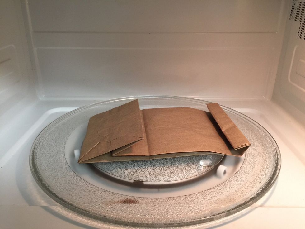 Place bag with kernels in the microwave and make sure it lies flat and all of the air is out