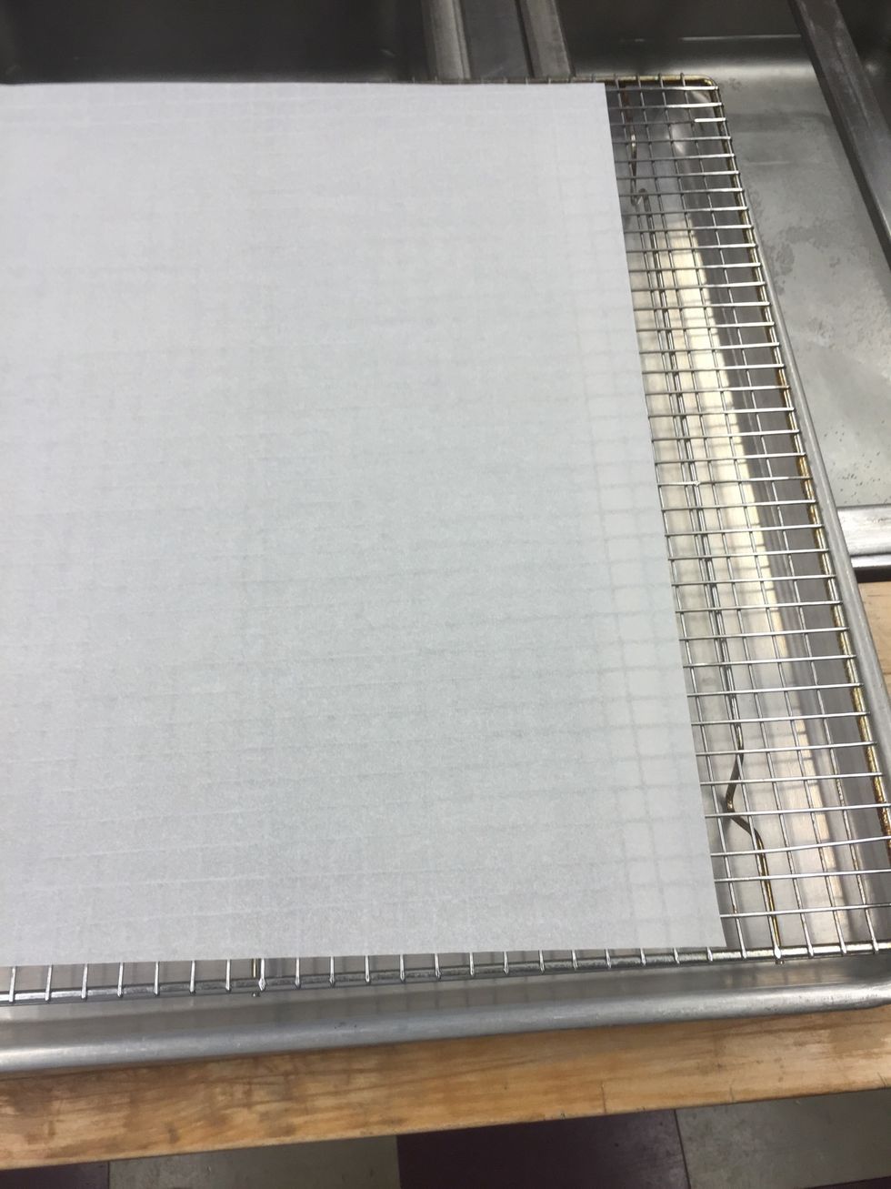 Place bakers rack on sheet pan and parchment on top.