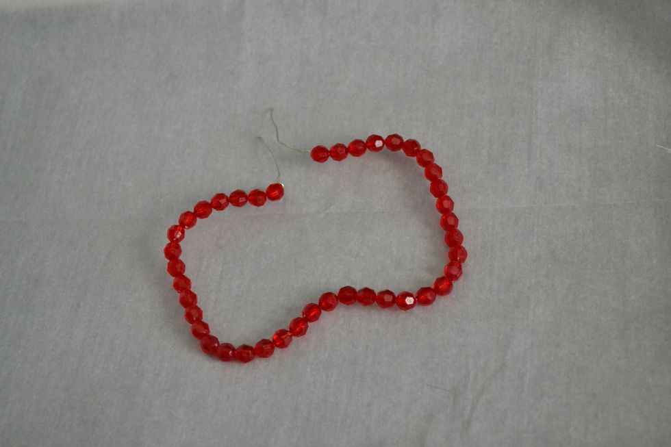 Place beads all the way around your jewelry wire or chenille stems (aka pipe cleaners).  I actually like using the wire better though. Leave some wire exposed to twist together to make the stem.