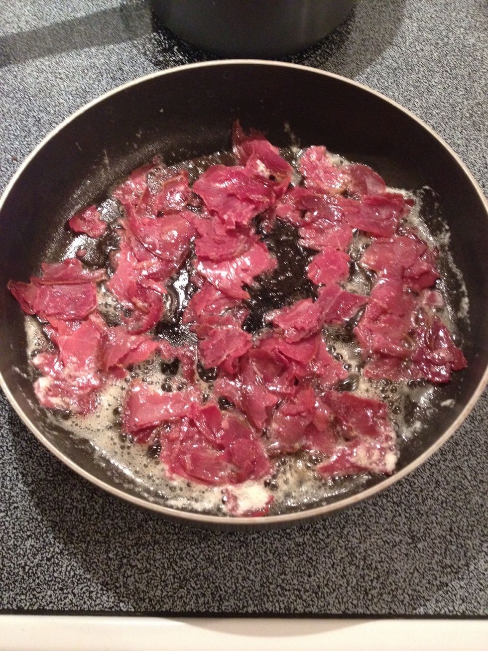 Place beef in butter and cook until edges start to brown and curl up.