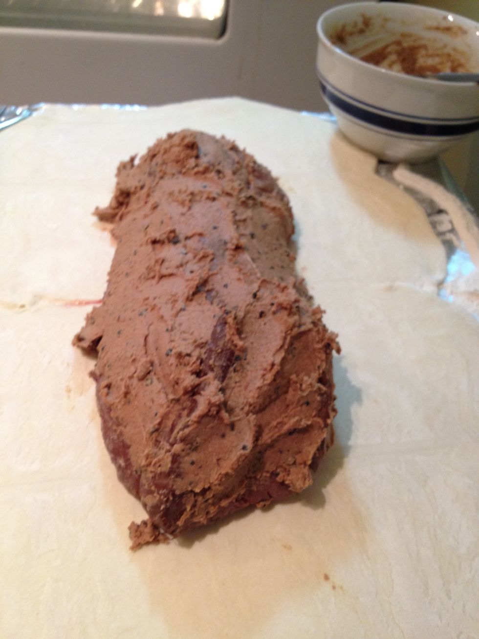 Place beef tenderloin on top of puffed pastry and slather the pate mixture all over the meat.