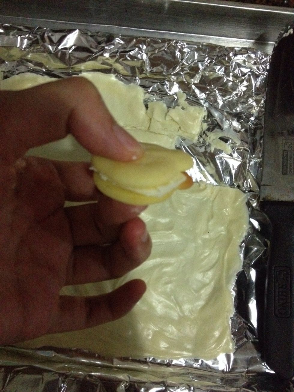 Place between two cookies and chill until the chocolate is hard.