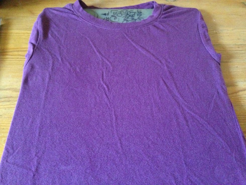 Place board inside shirt to avoid paint bleeding on other side.