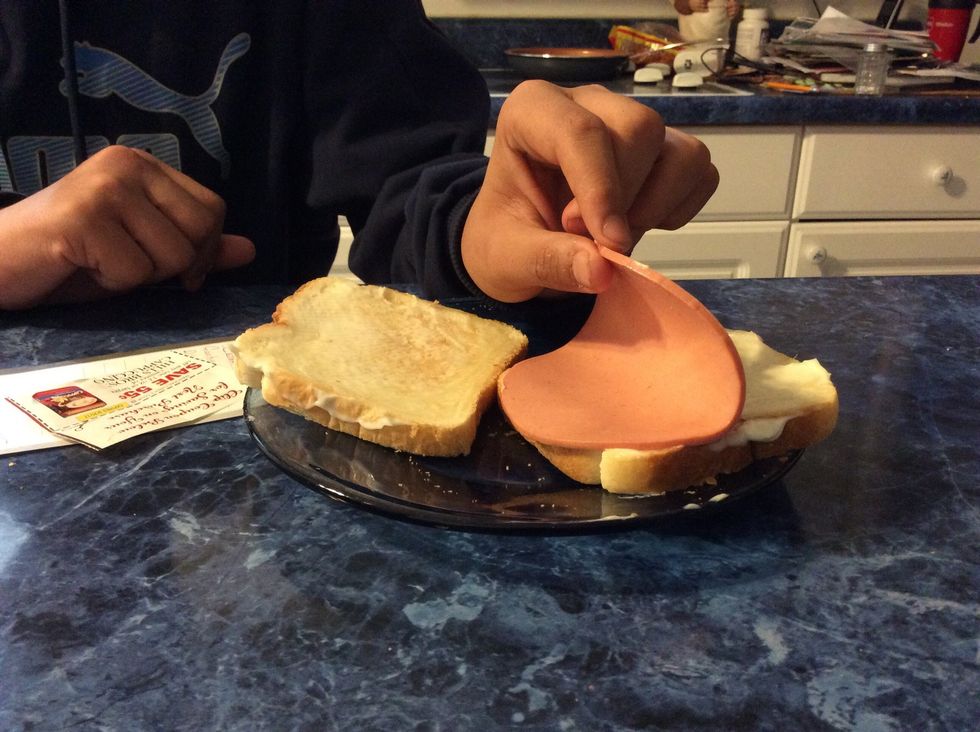 Place bologna on the bottom toast.