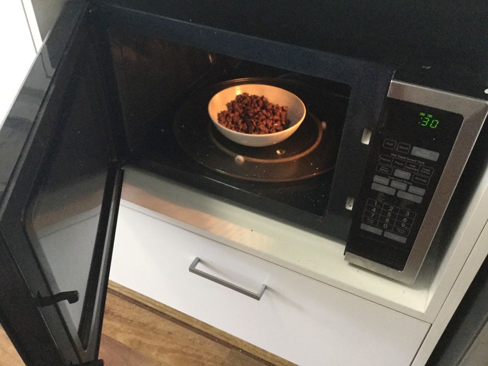 Place bowl in microwave for 30 seconds, stir then put in for 20 seconds. Then stir again. Make sure chocolate doesn't over heat.