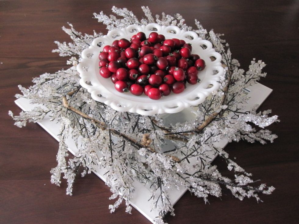 Place bowl on tray, berries in bowl, and wrap garland around the bowl