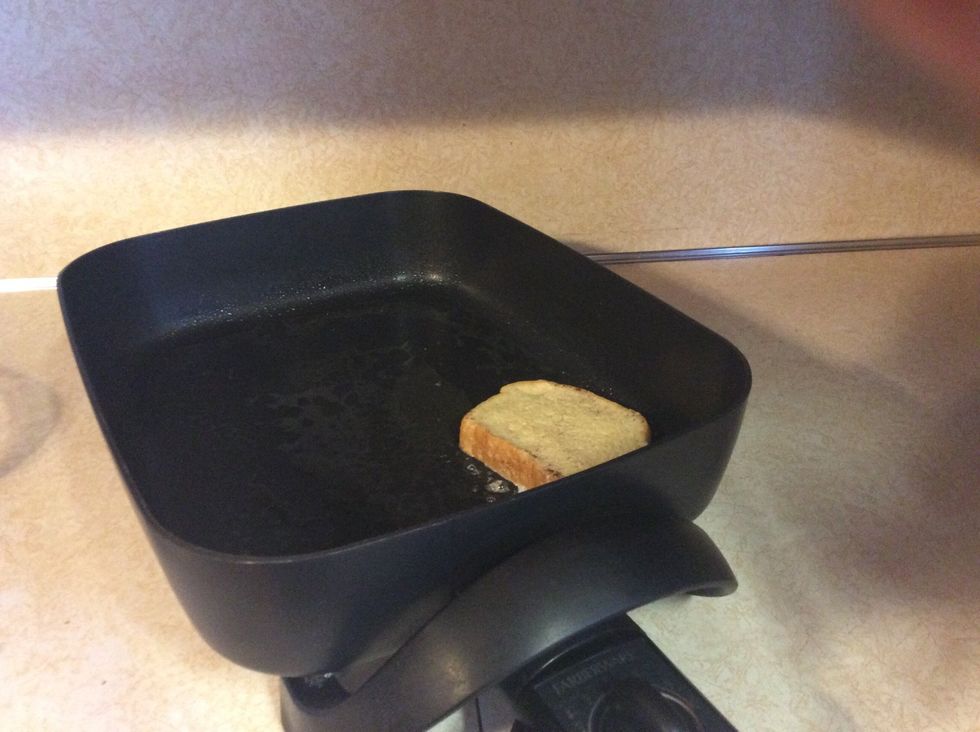 Place bread into skillet