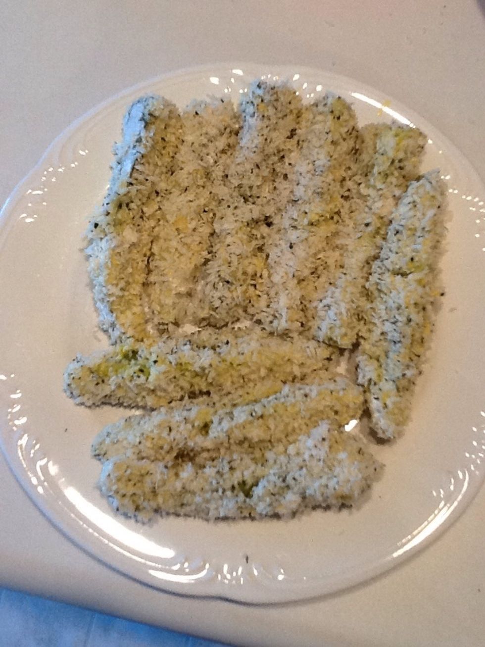 Place breaded pickles on a plate.