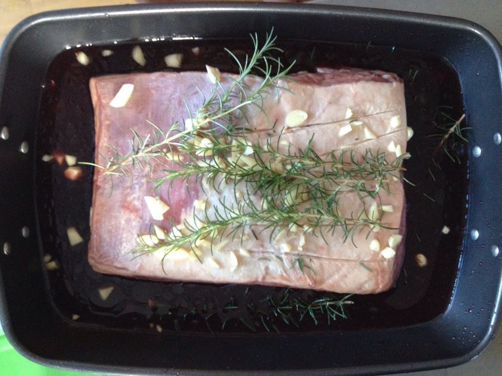 Place brisket in pan. Add garlic and rosemary. Pour enough wine to so that the brisket is half submerged. Preheat oven to 250C and place pan into oven. Immediately drop to 90C for 9hours