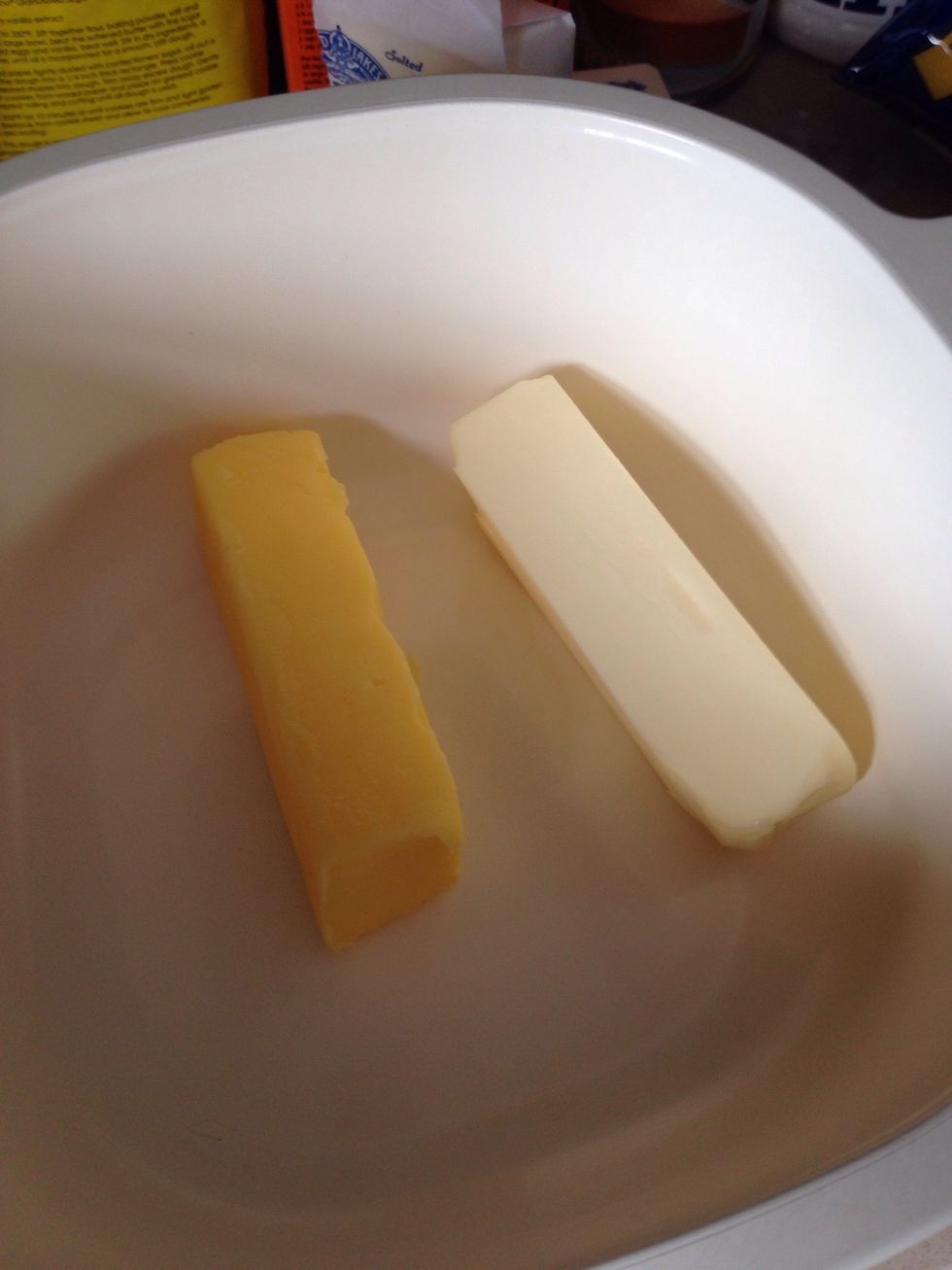Place butter and margarine in a microwave safe bowl and melt