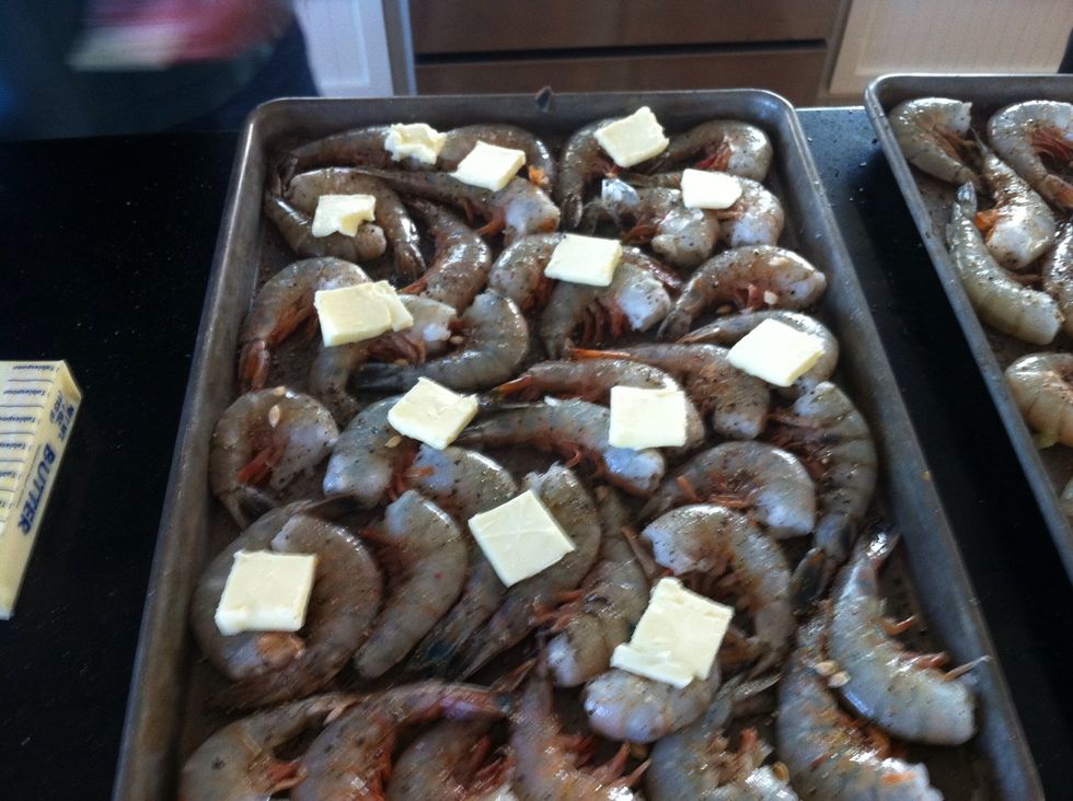 Place butter slices on shrimp