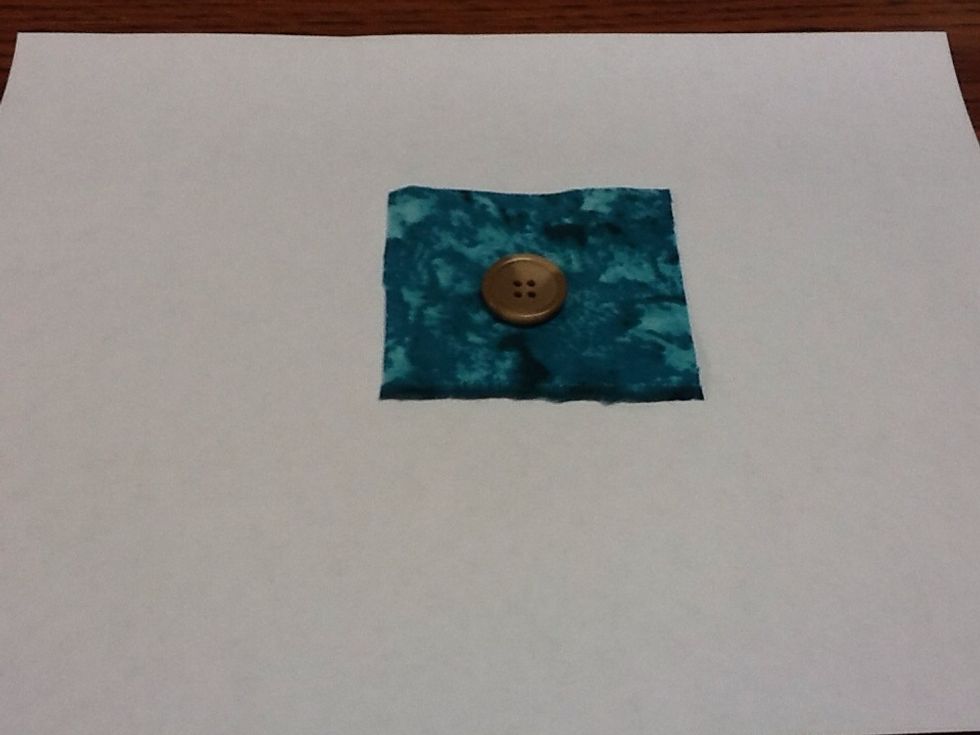 Place button in desired location of fabric