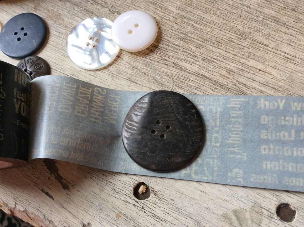 Place button on sticky side of washi tape. Try to find buttons that are nice and flat on one side.