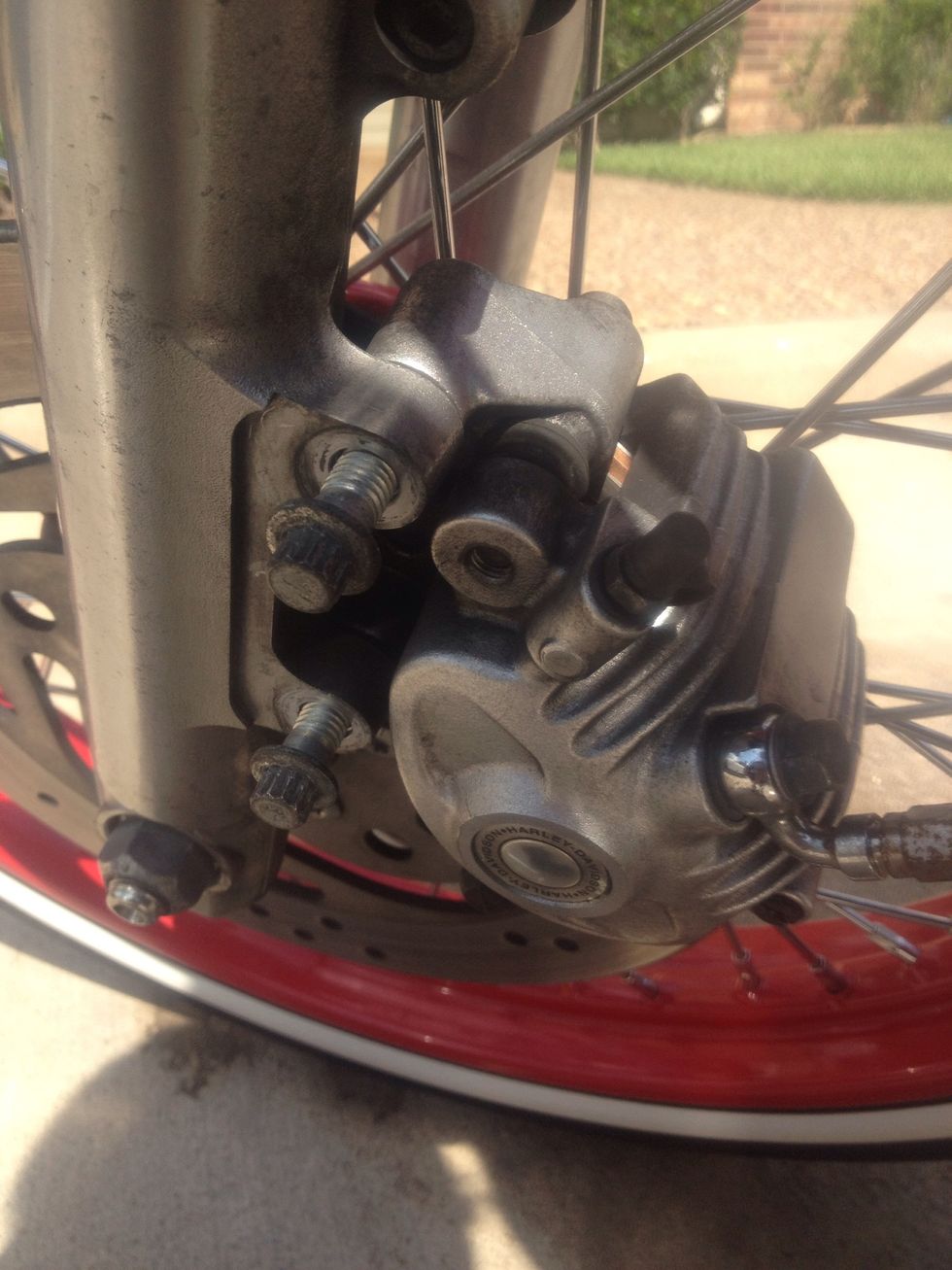 Place caliper over the rotor and align the two holes with the fork slider use the 10 mm wrech to tighten the caliper into place. Once the caliper is installed. Pump your front brake to get all air out