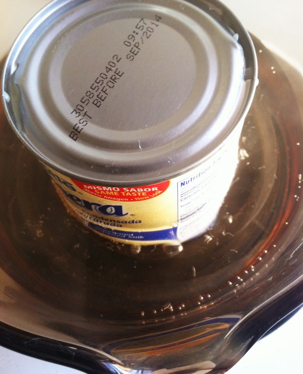 Place can in saucepan. Gently add water to 3/4 of the height of the can. Bring water to boil and then IMMEDIATELY reduce the heat to create the smallest bubbles.