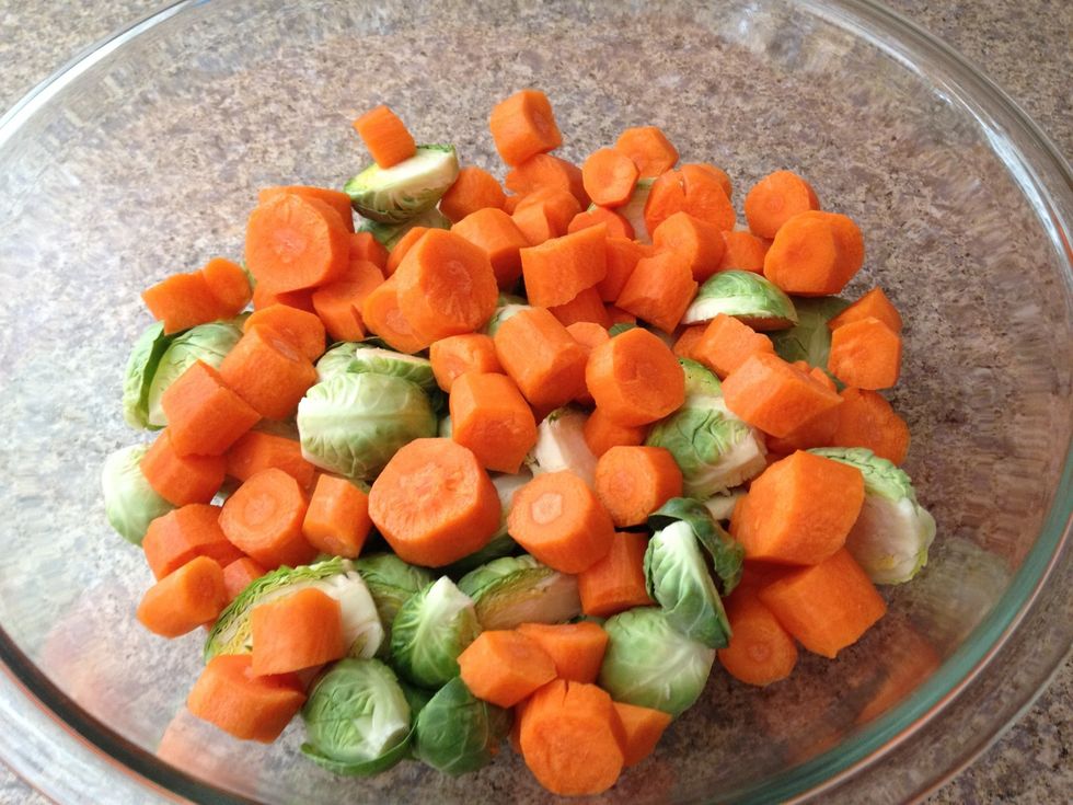 Place carrots and Brussels sprouts into a bowl