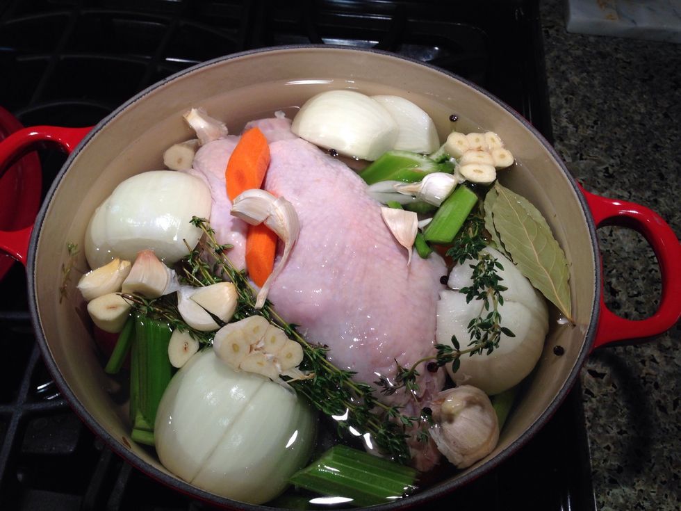 Place chicken and vegetables in large stockpot over medium heat.  Cover with 3 quarts of water. Add the bay leaves, thyme and peppercorns.  Simmer partially covered for 1 to 1.5 hours.